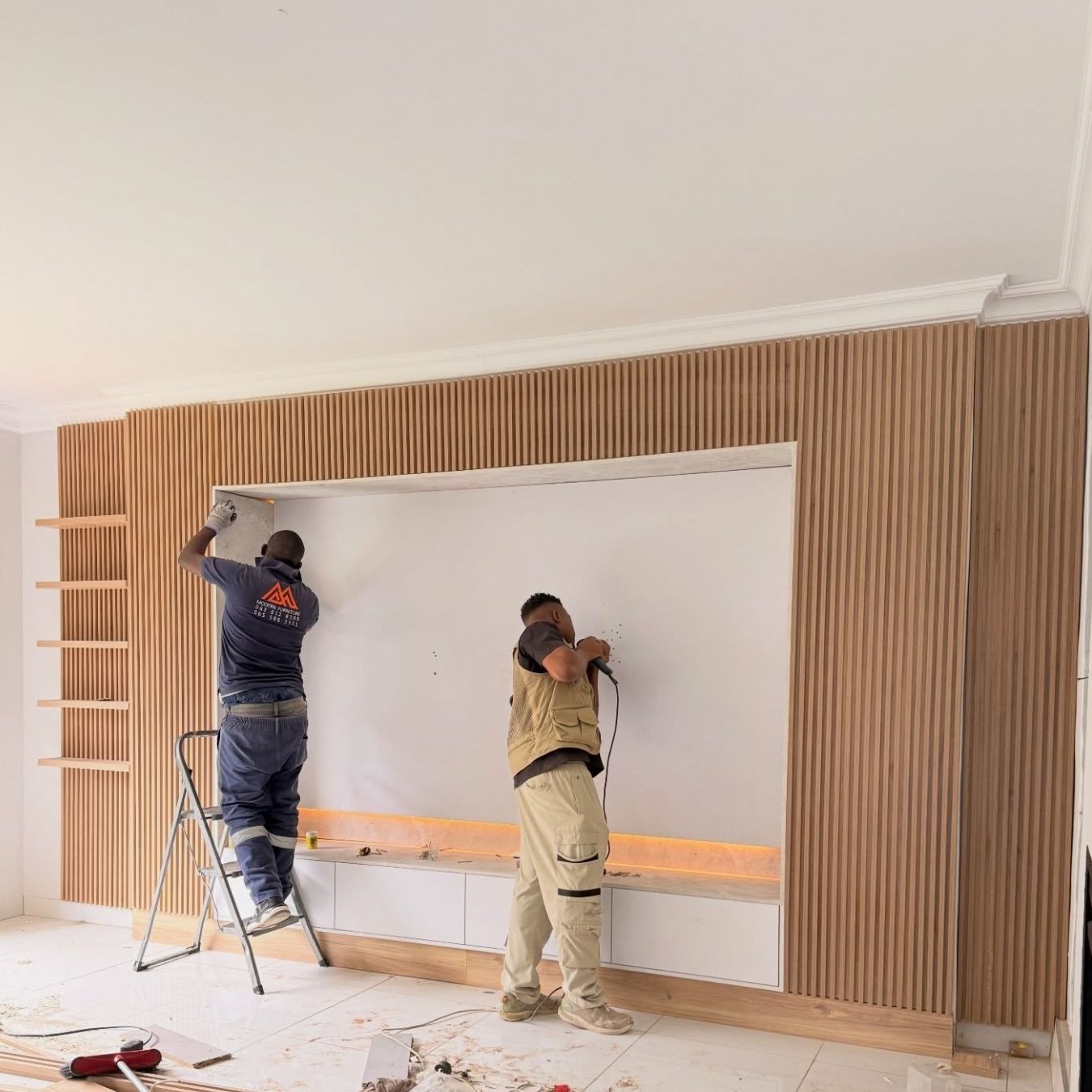 Custom oak slat panels installed and ambient LED channel set into the floating base.
