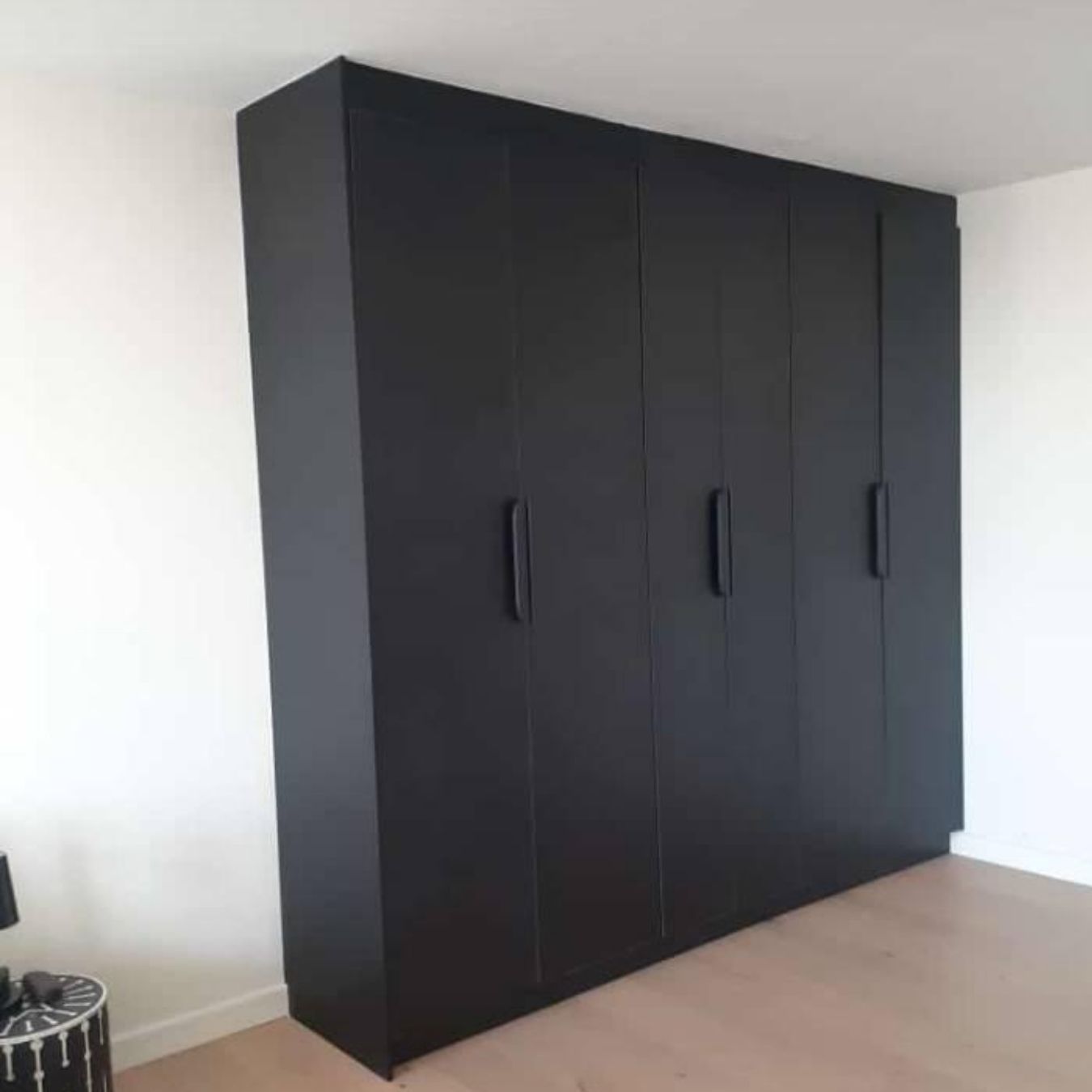 Floor-to-ceiling black wall unit