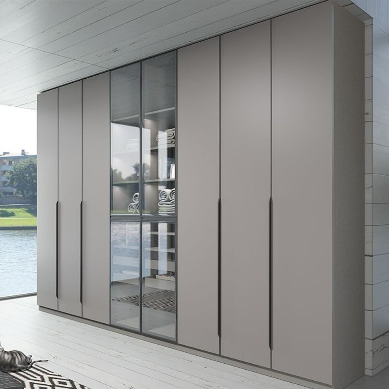 Wall-to-wall matte grey wardrobe with glass centre display